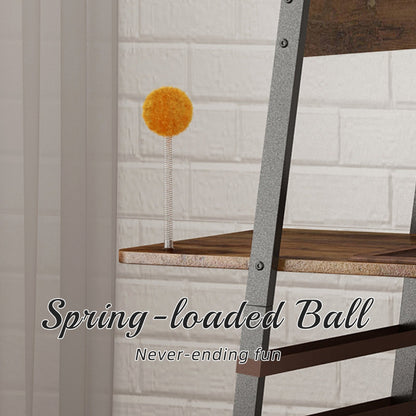 Close-up view of the yellow interactive spring-loaded toy ball mounted on the wooden platform of the rustic metal-framed cat tree tower