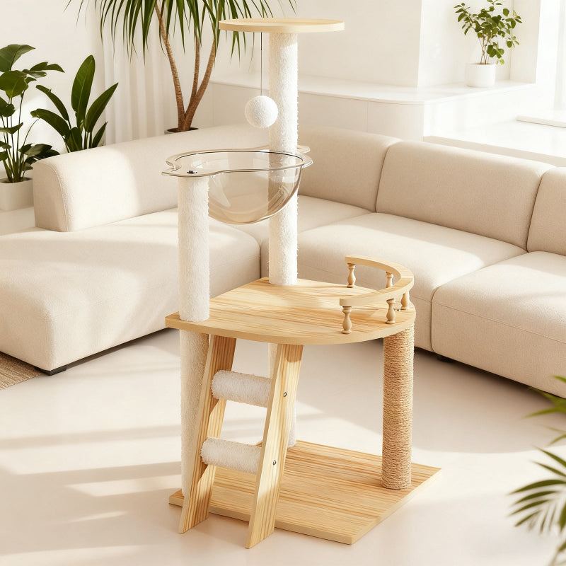 Modern wooden cat tree tower placed next to a beige sectional sofa in a bright living room with houseplants.