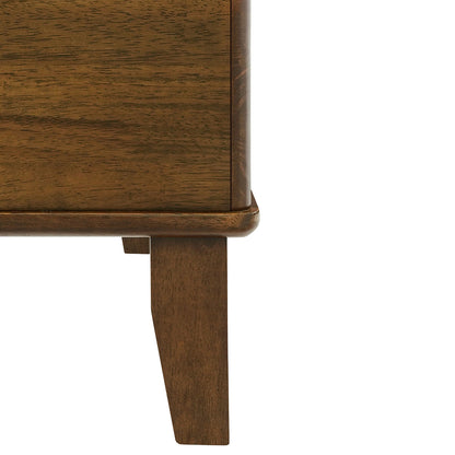 A close-up view of the sturdy wooden leg and smooth finished base corner of an ottoman furniture piece on a white background.