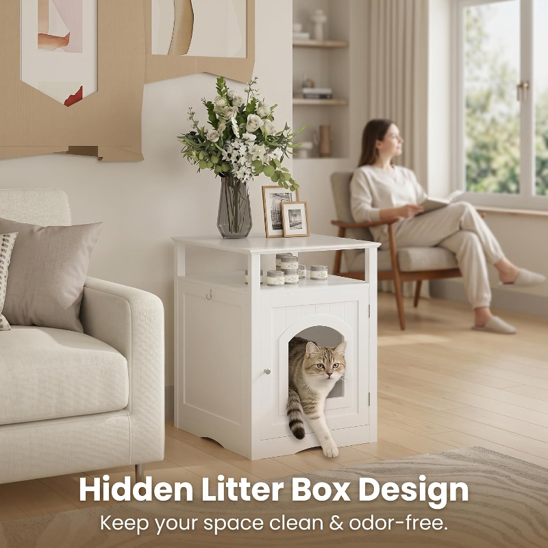 A white modern cat litter box enclosure functioning as a side table in a cozy living room, featuring a tabby cat stepping out from the arch door.