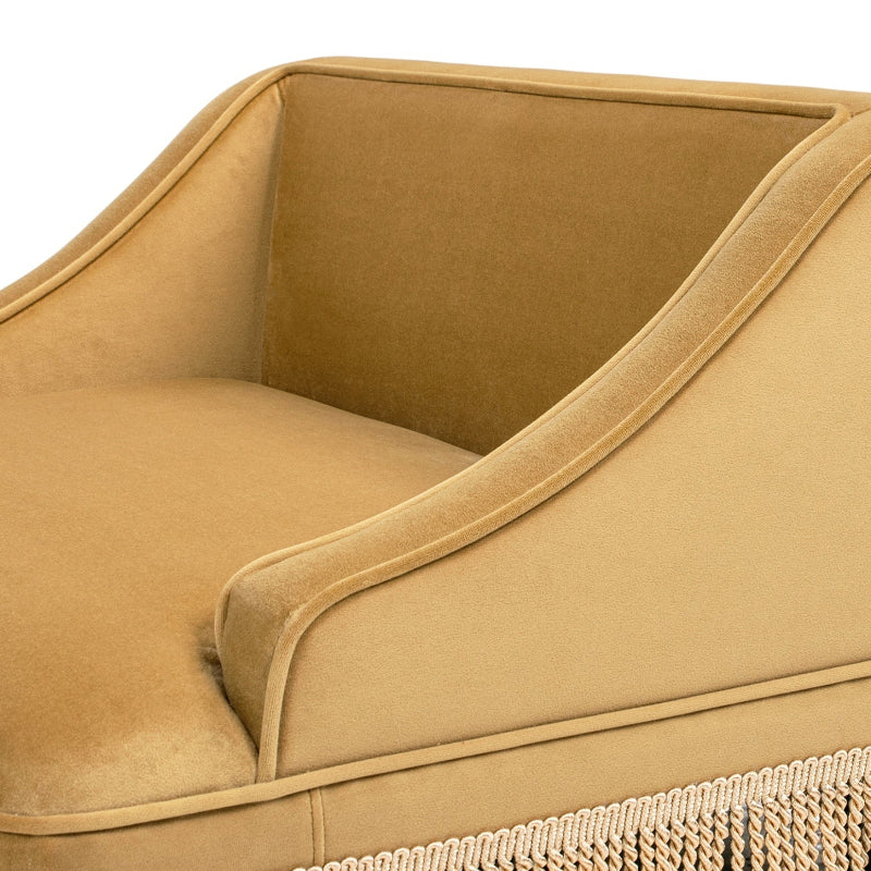 A close-up detail shot showing the soft velvet fabric, sturdy armrest, piping trim, and tassel fringe border of a yellow pet sofa.